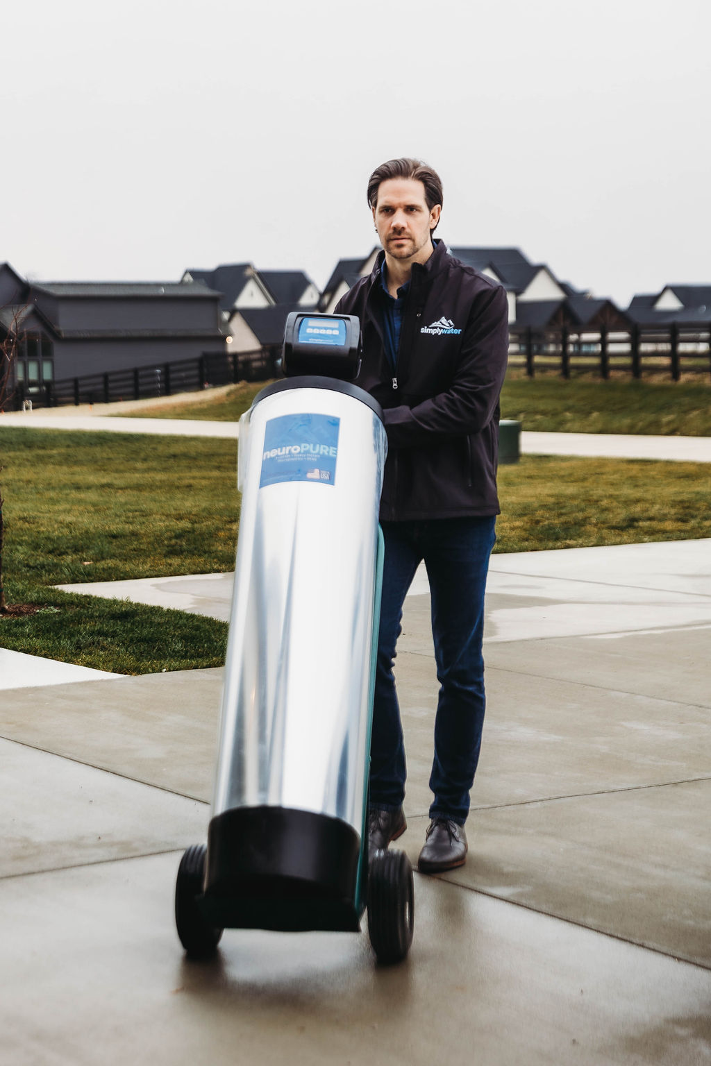 Simply Water team member walking a homeowner through an installed water treatment system