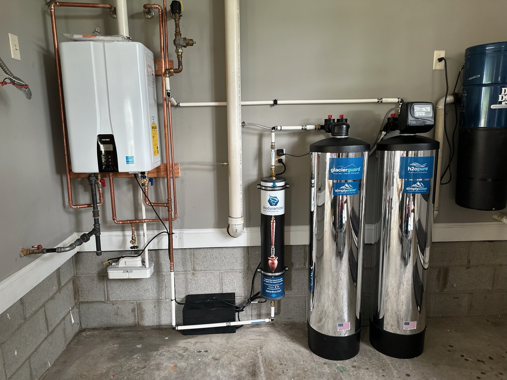 Simply Water treatment system installed in a residential utility room alongside existing plumbing